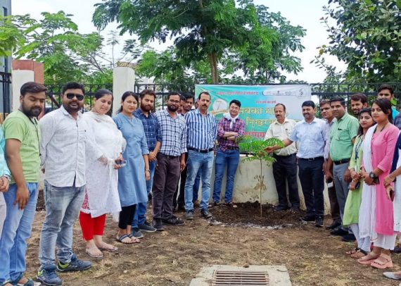 Members of Kalpdham Builders Group planting saplings as a team