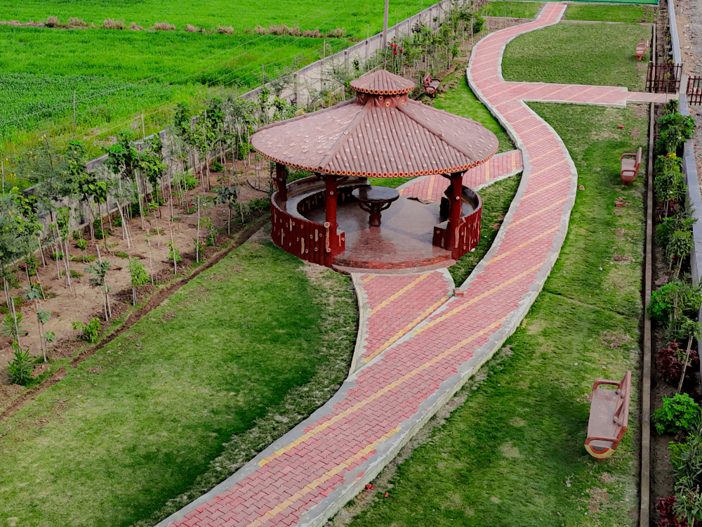 Serene hut and garden area in Gauri Greens Colony by Kalpdham Builders
